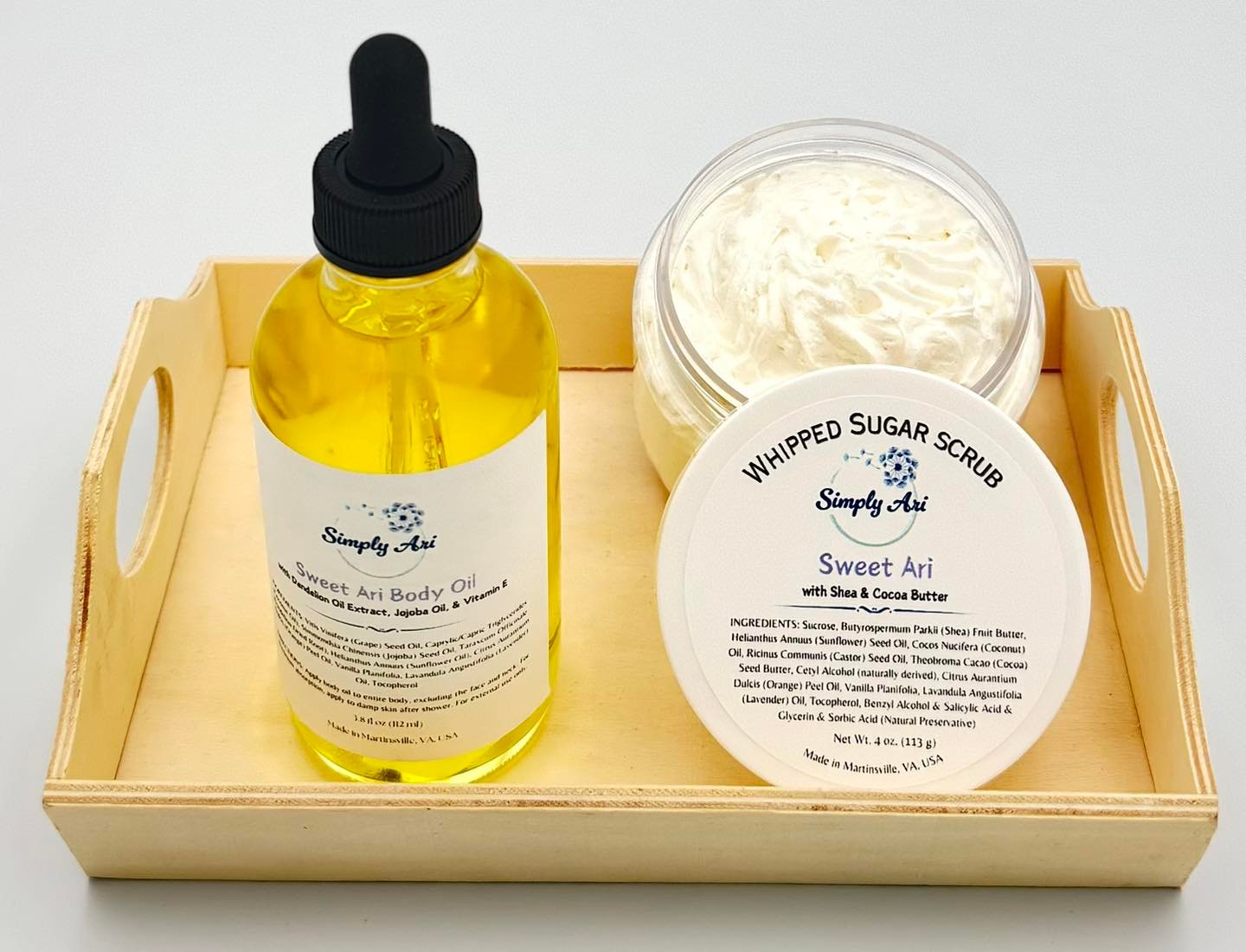 Simply Ari Sweet Ari Body Oil and Whipped Sugar Scrub on a wooden tray