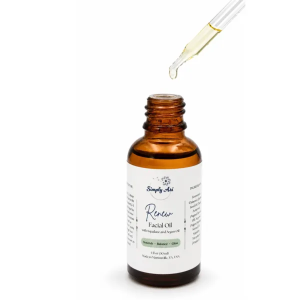 Amber glass dropper bottle of Simply Ari Renew Facial Oil with dropper dispensing oil above.